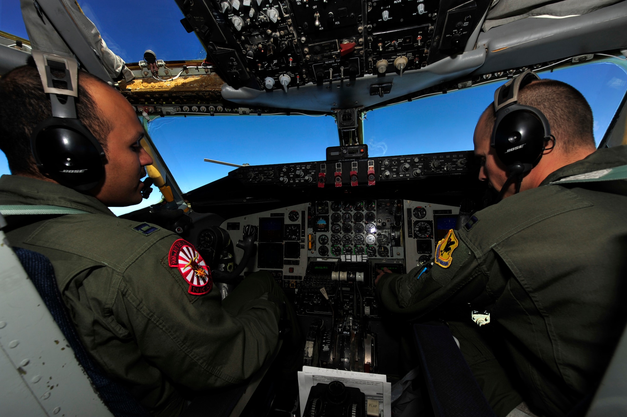 Capt.  John Chappelle, aircraft commander (left) and Capt. Rocky Harrisberger, co-pilot both from the 909th Air Refueling Squadron, Kadena Air Base; discuss the intricacies of the mission after providing seven F-16 Fighting Falcons from the 14th Fighter Squadron, Misawa Air Base with fuel while flying over the Sea of Japan March 27.  The 14 FS is conducting a routine operational training deployment to Kunsan Air Base, Republic of Korea for the next few weeks. The KC-135 provides aerial refueling support to Air Force, Navy and Marine Corps aircraft as well as aircraft of allied nations. (U.S. Air Force photo/Staff Sgt. Lakisha A. Croley)
