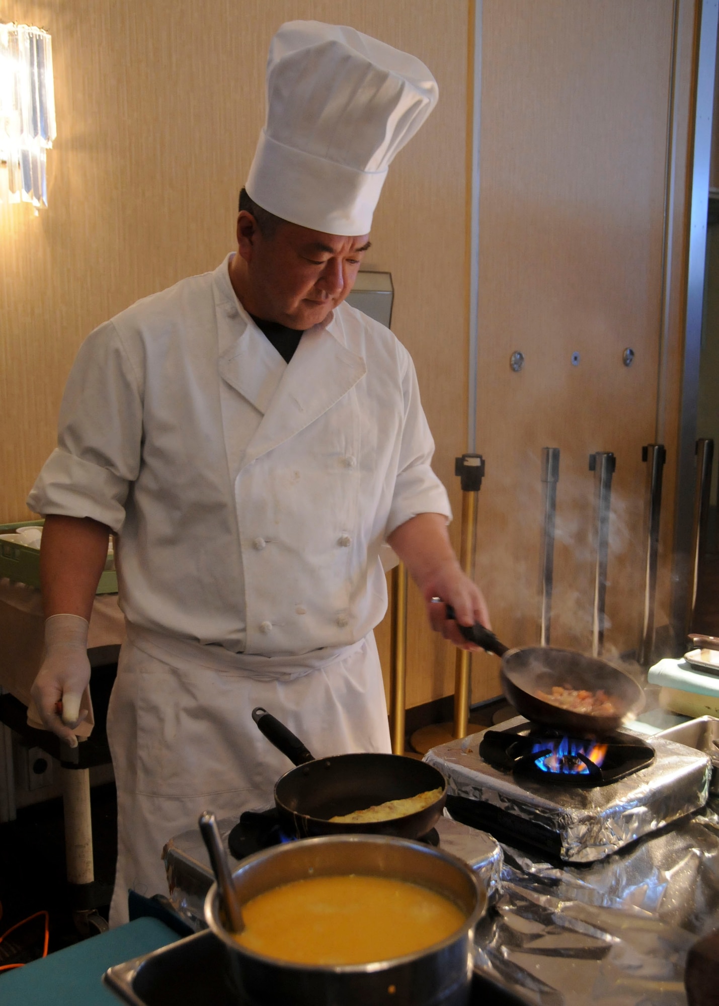 MISAWA AIR BASE, Japan -- A chef employed by the 35th Force Support Squadron cooks omelets at the collocated club's Sunday brunch buffet March 27. While many base services have returned to normal operations, the base continues to operate under limited power capability as a result of the March 11 earthquake. (U.S. Air Force photo by Staff Sgt. Rachel Martinez/Released)