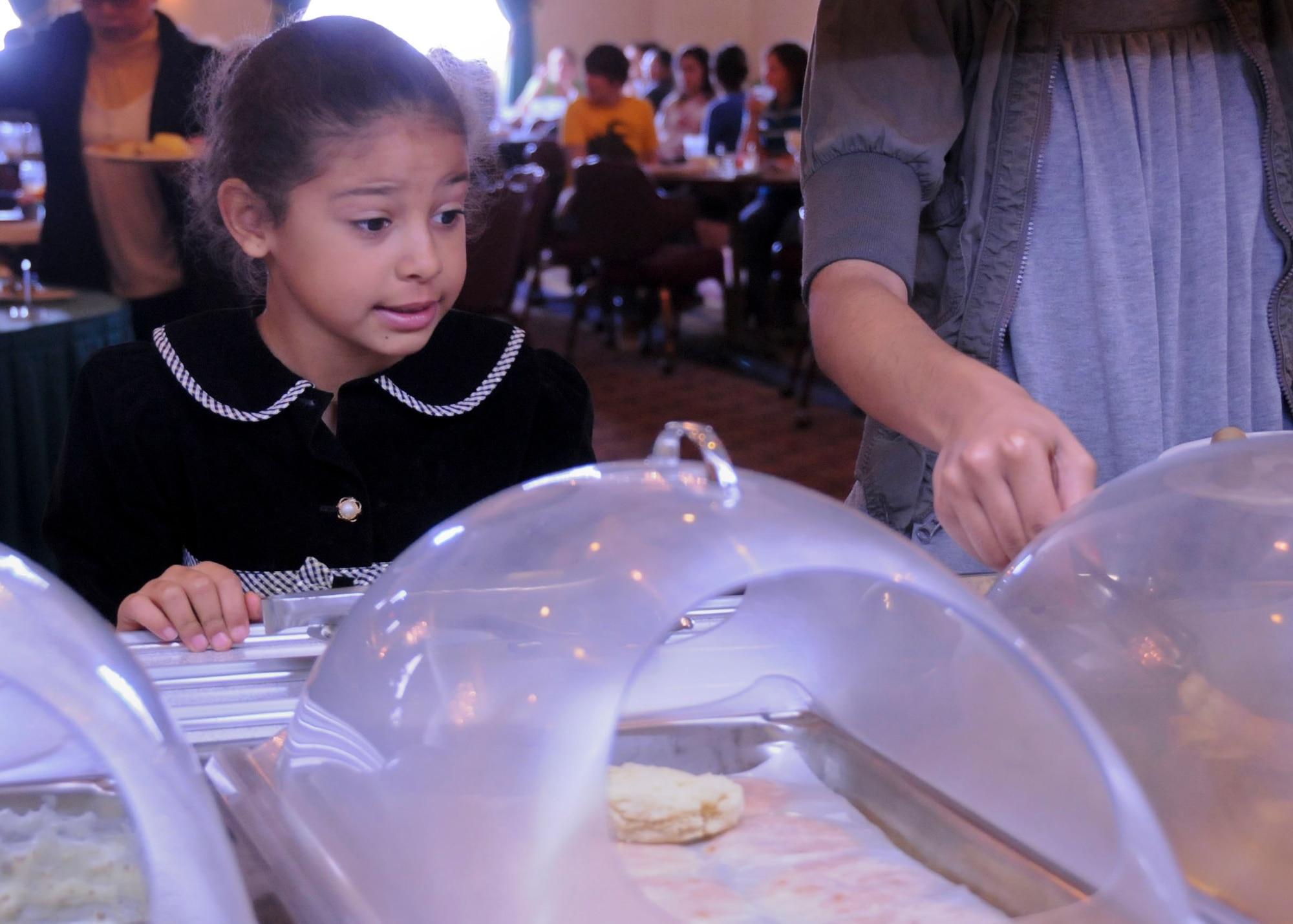MISAWA AIR BASE, Japan -- Darianne Ruffin, age 6, eyes the selection of food at the collocated club's Sunday brunch March 27. This was the first Sunday brunch offered since an earthquake struck Japan March 11. (U.S. Air Force photo by Staff Sgt. Rachel Martinez/Released)