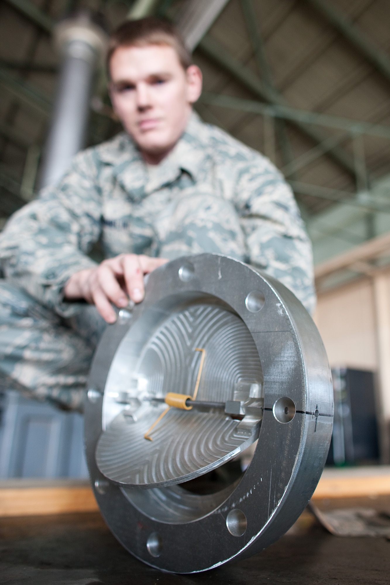 YOKOTA AIR BASE, Japan -- Airman 1st Class Jeremy Hamblin, 374th Maintenance Squadron, delivers a component for a water pump March 27, 2011. Two teams of four Airmen on 12-hour shifts designed and created the necessary adapters, pressure valves and other pieces so Japanese crews could use the pumps to augment the plant’s cooling system. The pumps will be used to transport fresh water into the plant instead of ocean water, which leaves corroding salt residue when it evaporates. The project is one more way Team Yokota has supported Operation Tomodachi, the overall relief mission to help the Japanese people in their recovery efforts.  (U.S. Air Force photo/Osakabe Yasuo)