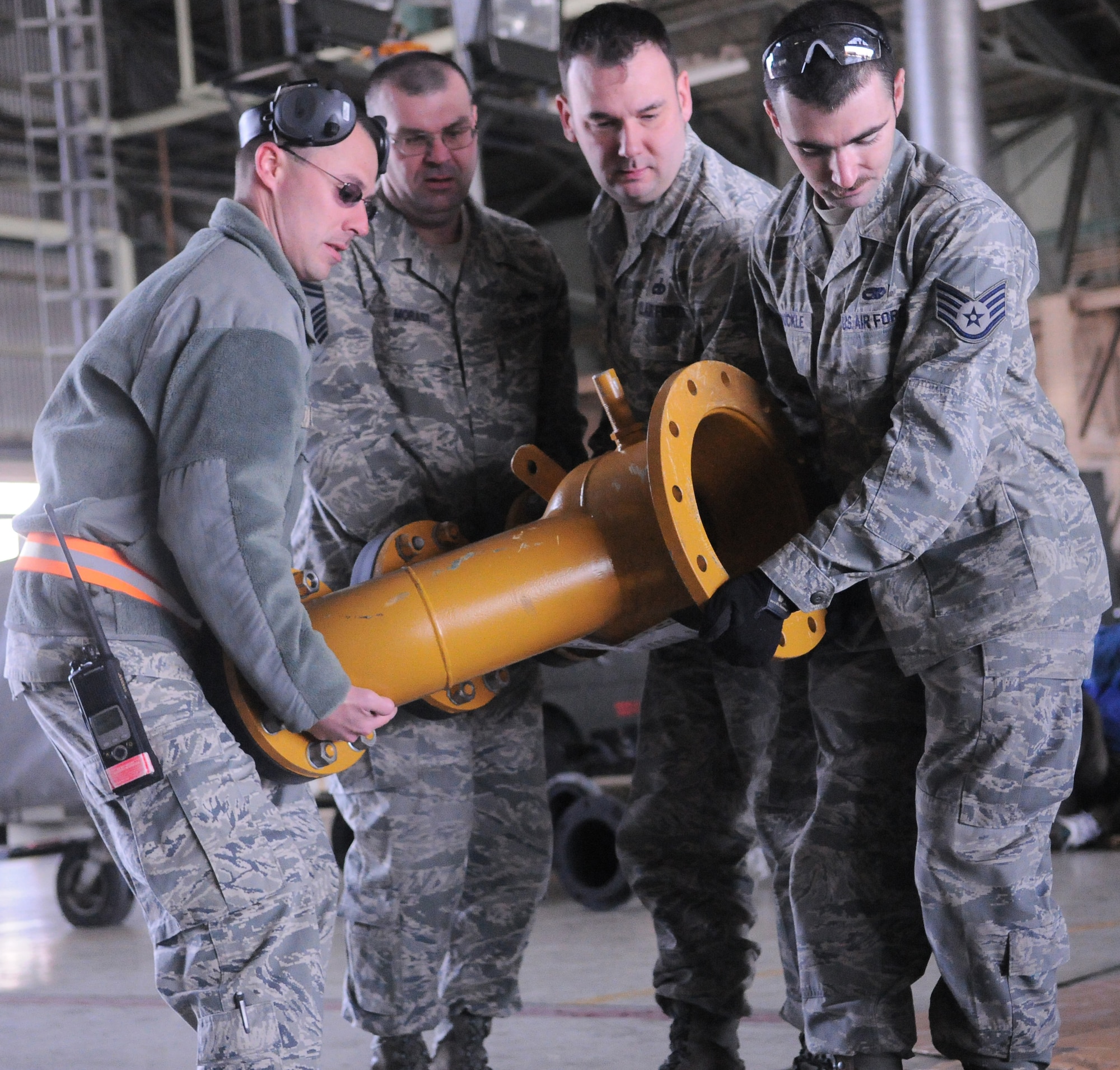 YOKOTA AIR BASE, Japan -- Airmen from the 374th Maintenance Squadron carry a custom made reduction flange here March 26. Two teams of four Airmen on 12-hour shifts designed and created the necessary adapters, pressure valves and other pieces so Japanese crews can use a water pump - donated by the US government - to augment the Fukushima nuclear plant’s cooling system. The pump will be used to transport fresh water into the plant instead of ocean water, which leaves corroding salt residue when it evaporates. The project is one more way Team Yokota has supported Operation Tomodachi, the overall relief mission to help the Japanese people in their recovery efforts. (U.S. Air Force photo/Airman 1st Class Krystal M. Garrett)  

