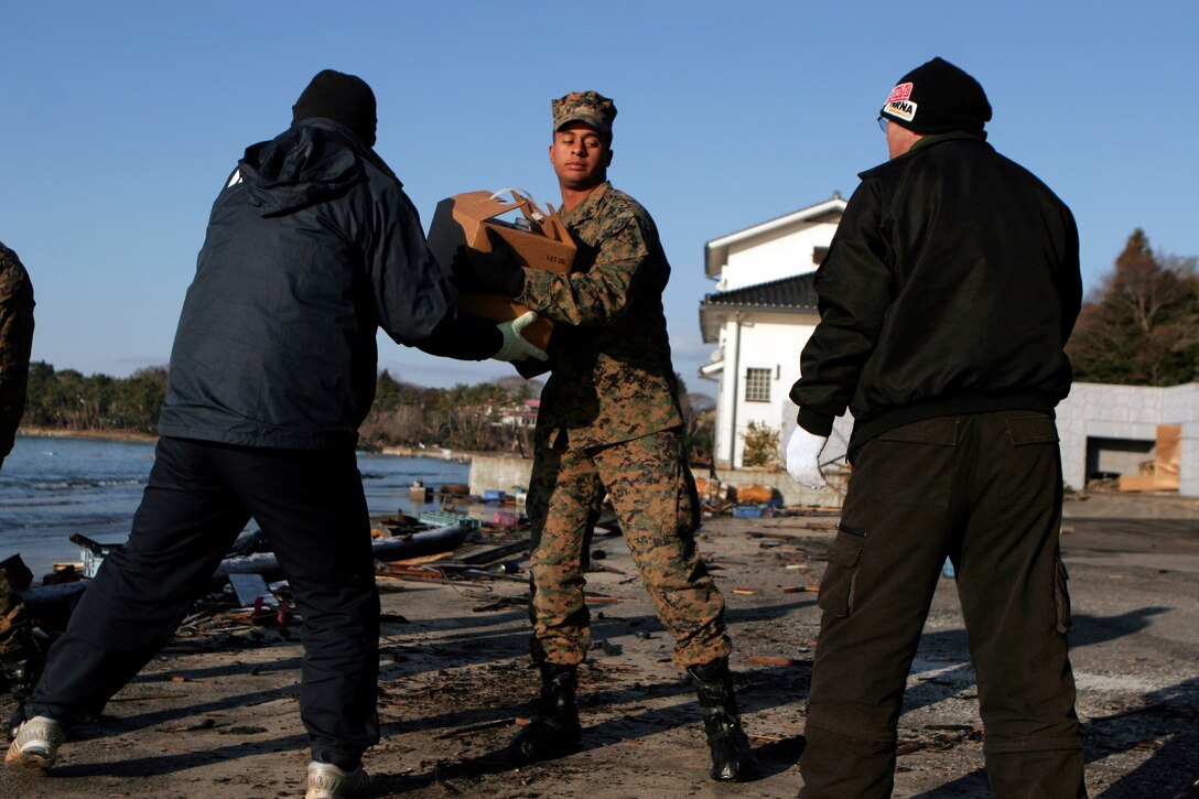 A Marine with the 31st Marine Expeditionary Unit, helps Japanese locals unload a U.S. Navy landing craft here, March 27. The 31st Marine Expeditionary Unit delivered food, water, health and comfort supplies, and Japanese electrical utility vehicles to the isolated island of Oshima, in conjunction with Japanese Self-Defense Forces. The 31st MEU’s involvement is part of a larger U.S. government response, after a 9.0 earthquake and subsequent tsunami struck Japan causing widespread damage. The 31st MEU is ready to support our Japanese partners and to provide assistance when called upon.