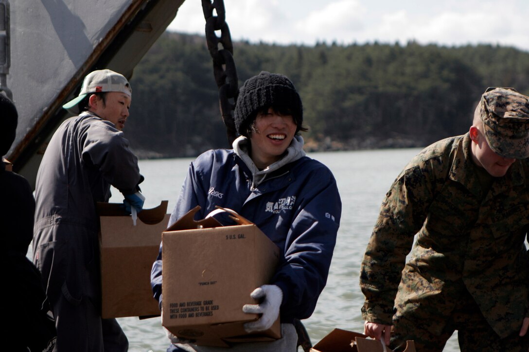 A Japanese local smiles while unloading supplies from a landing craft utility, March 27. The 31st Marine Expeditionary Unit and Amphibious Squadron 11 delivered food, water, health and comfort supplies, and Japanese electrical utility vehicles to the isolated island of Oshima, in conjunction with Japanese Self-Defense Forces. The 31st MEU’s involvement is part of a larger U.S. government response, after a 9.0 earthquake and subsequent tsunami struck Japan causing widespread damage. The 31st MEU is ready to support our Japanese partners and to provide assistance when called upon.