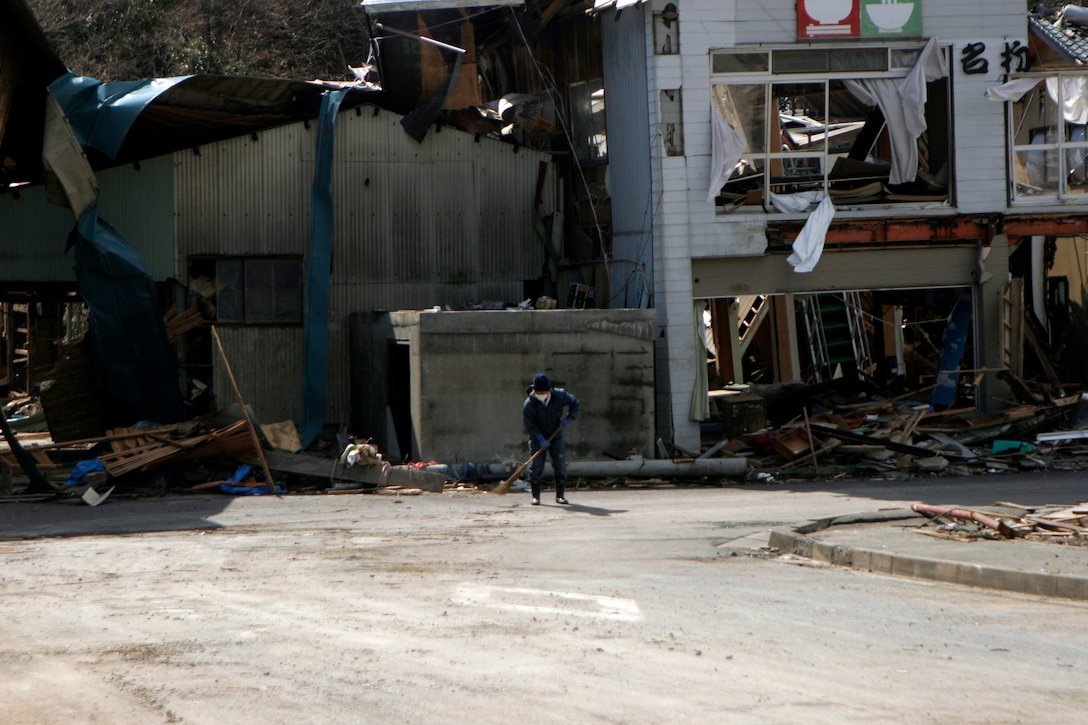 A Japanese man sweeps a street on Oshima Island, March 27. The 31st Marine Expeditionary Unit delivered food, water, health and comfort supplies, and Japanese electrical utility vehicles to the isolated island, in conjunction with Japanese Self-Defense Forces. The 31st MEU’s involvement is part of a larger U.S. government response, after a 9.0 earthquake and subsequent tsunami struck Japan causing widespread damage. The 31st MEU is ready to support our Japanese partners and to provide assistance when called upon.