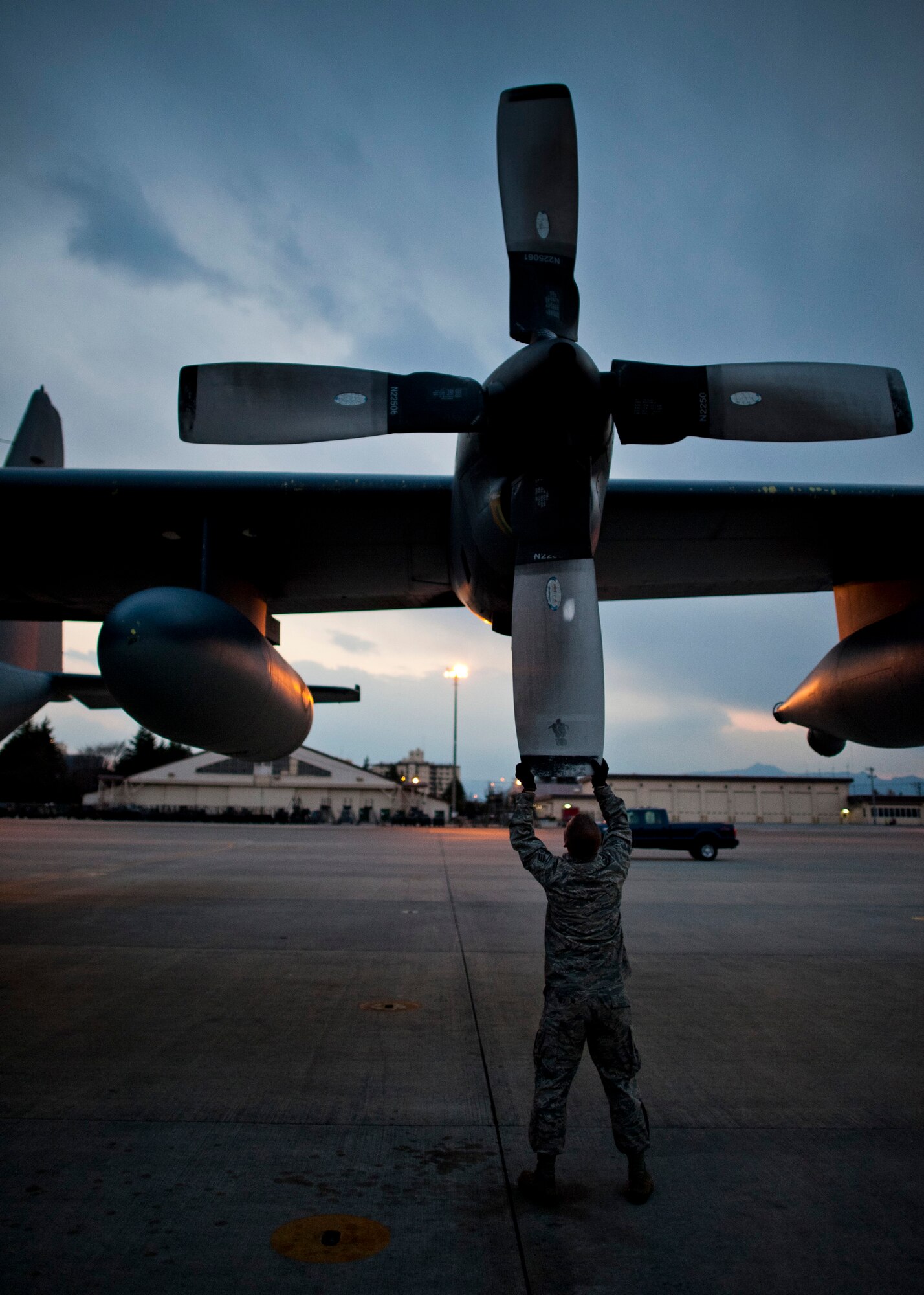 YOKOTA AIR BASE, Japan -- A crewchief from the 353rd Special Operations Group checks the propellers of an MC-130P Combat Shadow at Yokota Air Base, Japan, March 28, 2011. Air Force aircraft are checked thoroughly before and after flight to ensure they are in prime condition to keep their flight crew and cargo safe. (U.S. Air Force photo/Staff Sgt. Samuel Morse)