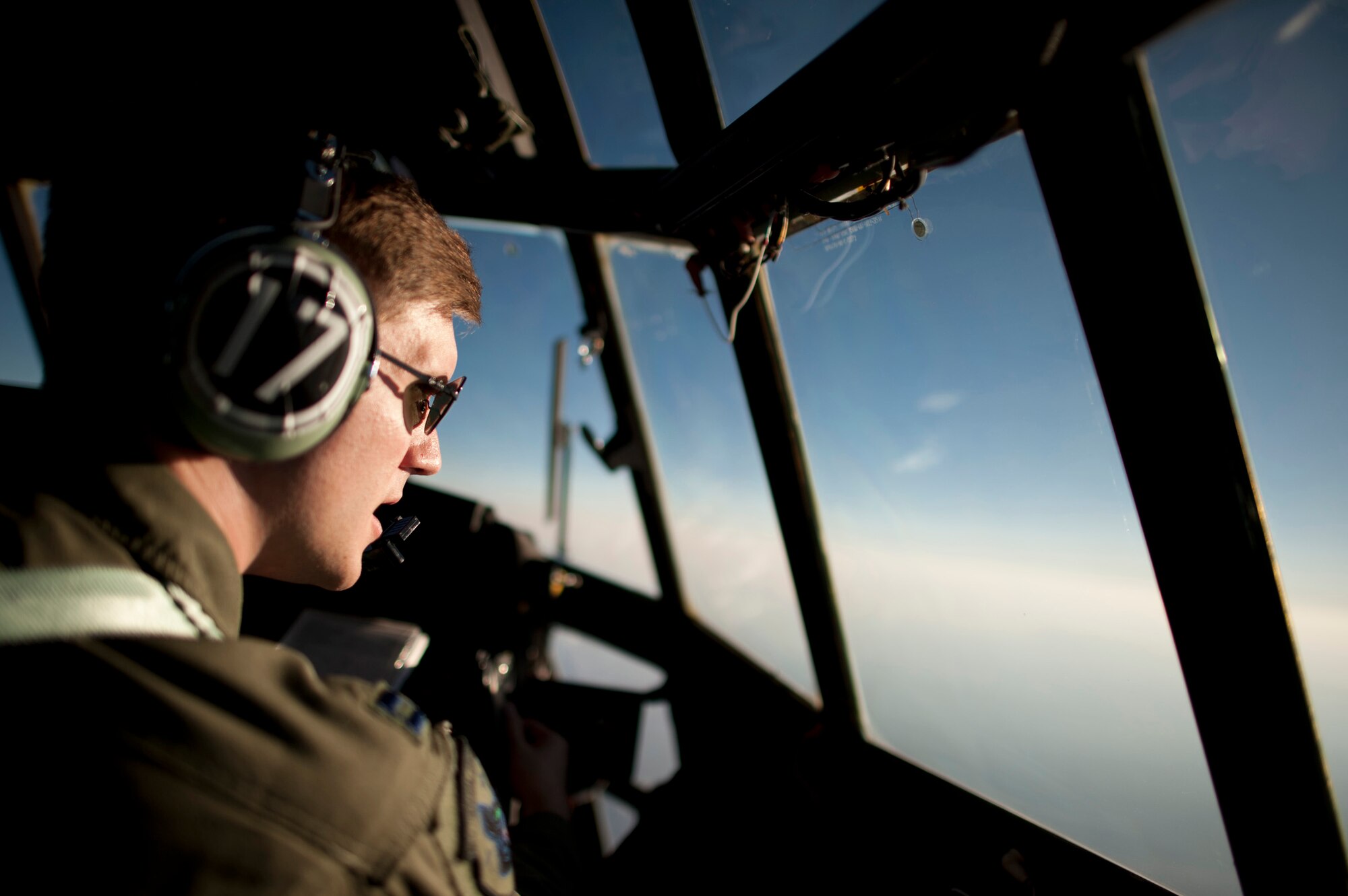 OVER JAPAN -- A copilot with the 353rd Special Operations Group looks out the window of an MC-130P Combat Shadow March 28, 2011. The MC-130P carried fuel and humanitarian aid to help the citizens of Sendai. (U.S. Air Force photo/Staff Sgt. Samuel Morse)