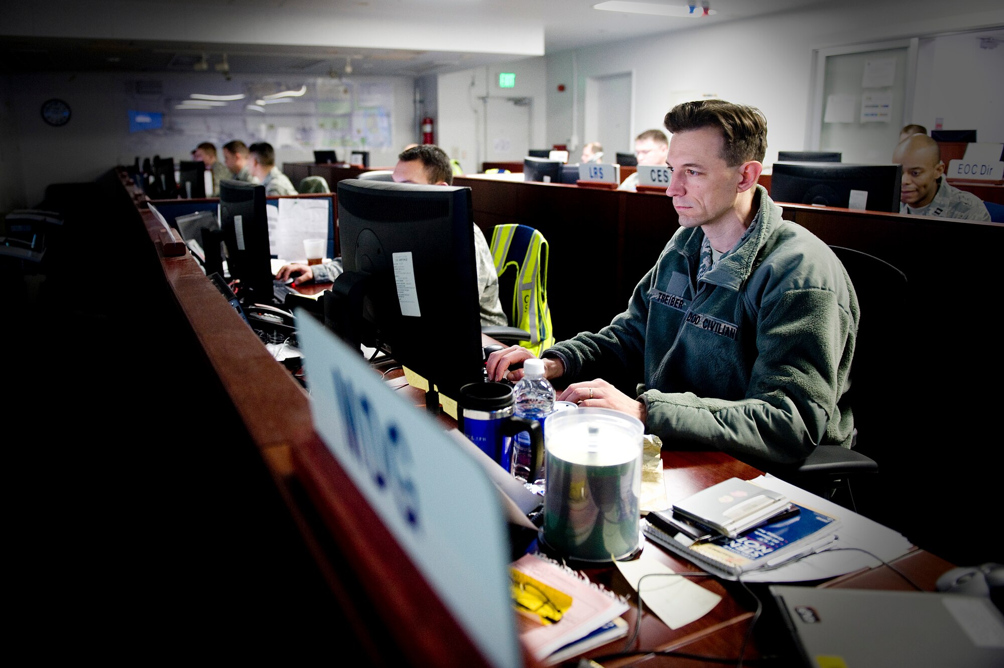 YOKOTA AIR BASE, Japan -- Representatives from Yokota's Installation Control Center and Emergency Operations Center work together to collect and track information here, March 28, in support of Operation Tomodachi. (U.S. Air Force photo / Staff Sgt. Jonathan Steffen)