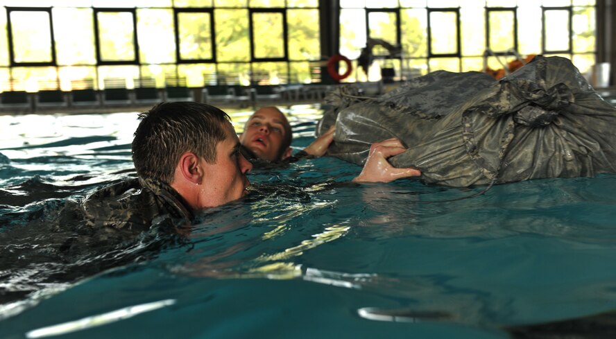 MOODY AIR FORCE BASE, Ga.-- Trainees push rucksacks through water during a water confidence exercise testing their team work March 23. The trainees participated in the air liaison officer training course which required them to perform task from land navigation, ruck marches and tactical combat. (U.S. Air Force photo/Airman 1st Class Joshua Green)(RELEASED)
