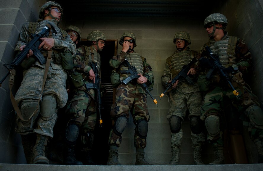 MOODY AIR FORCE BASE, Ga.-- A group of trainees makes radio contact with their other unit during a combat portion of air liaison officer training March 24. The trainees were tasked to tactically move through military operations in urban terrain village training facility clearing buildings and finding the location of their wingman left behind while creating extraction. (U.S. Air Force photo/Airman 1st Class Joshua Green)(RELEASED)
