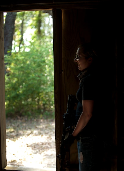 MOODY AIR FORCE BASE, Ga.-- Senior Airman Victoria Cooper, 93rd Air Ground Operations Wing knowledge operation manager, ducks in the shadows during a combat portion of air liaison officer training March 24. Airman Cooper participated as one of the opposing forces during the training providing a realistic scenario for the trainees. (U.S. Air Force photo/Airman 1st Class Joshua Green)(RELEASED)
