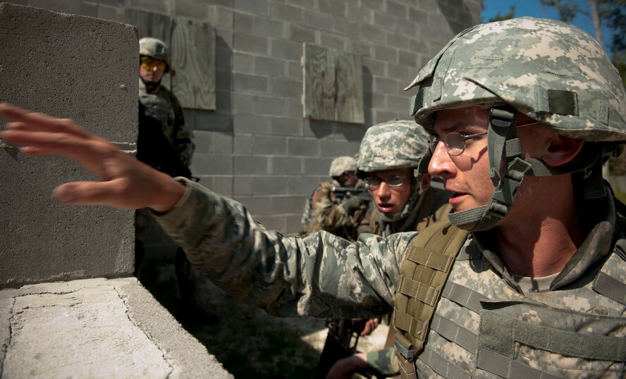 MOODY AIR FORCE BASE, Ga.-- U.S. Air Force Academy cadet Andrew Jaris, takes point during a combat portion of air liaison officer training March 24. Cadet Jaris gave orders for his fellow trainees to move forward and take cover next to a building while radioing for back up. (U.S. Air Force photo/Airman 1st Class Joshua Green)(RELEASED)
