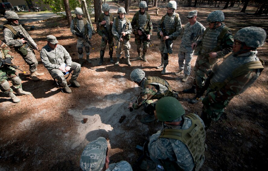 MOODY AIR FORCE BASE, Ga.-- Trainees participating in the air liaison officer training course explain to one of the cadre their plan of action during a combat exercise at the military operations in urban terrain village training facility March 24. The trainees were tasked with a mission that involved clearing buildings and finding a wingman left behind. (U.S. Air Force photo/Airman 1st Class Joshua Green)(RELEASED)
