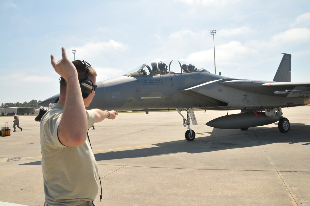 Staff Sgt. David Evinger, a 173rd Fighter Wing Crew Chief waves out an F-15 piloted by Lt. Col. Chris “Gump” Morton  during flight exercises at Tyndall Air Force Base, Fla. March 22, 2011.  Kingsley pilots are working with F-22 Raptor students to introduce them to combat with dissimilar aircraft in the skies over the Florida panhandle.  (U.S. Air Force photo by Tech. Sgt. Jefferson Thompson) RELEASED