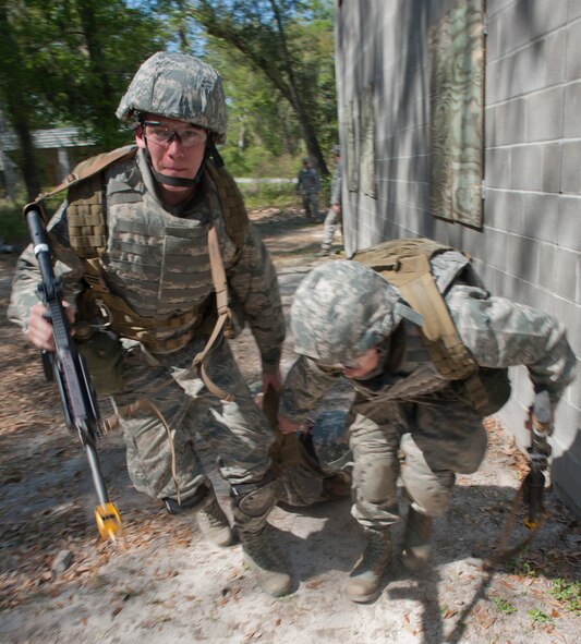 MOODY AIR FORCE BASE, Ga. -- U.S. Air Force Academy cadet James Kearney and another member of his team pull a simulated downed member out of combat during a simulation at the military operations in urban terrain training village March 24. This was part of an assessment that judged the participants on how well they perform physically and mentally and whether or not they can become an air liaison officer  (U.S. Air Force photo/Airman 1st Class Nicholas Benroth)(RELEASED)