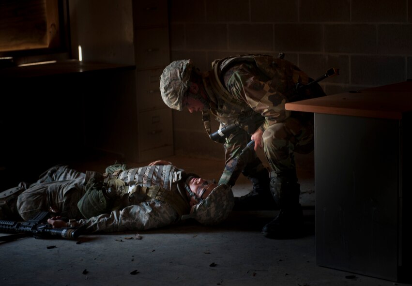 MOODY AIR FORCE BASE, Ga. -- Air Force ROTC cadet Chris Skorenki looks over one of his simulated fallen team members after they attempted to clear a room and rescue a captured team member March 24. This was part of an exercise at the military operations in urban terrain training village that tested the wits and determination of the participants. (U.S. Air Force photo/Airman 1st Class Nicholas Benroth)(RELEASED)