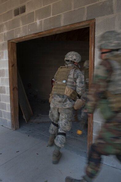 MOODY AIR FORCE BASE, Ga. -- A team made up of participants in the air liaison officer aptitude assessment breach a room after taking down an enemy inside March 24. This scenario took place at the military operations in urban terrain training village here where the teams had to attack an unknown force and on one mission retrieve a fallen comrade. (U.S. Air Force photo/Airman 1st Class Nicholas Benroth)(RELEASED)