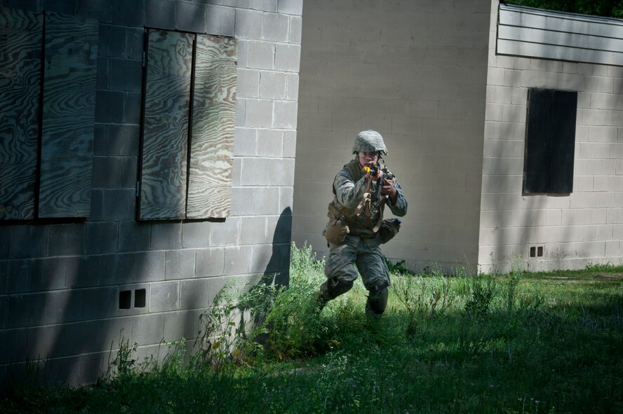 MOODY AIR FORCE BASE, Ga. -- Capt. Adrian Simental, 49th Materiel Maintenance Support Squadron operations officer from Holloman Air Force Base, N.M., moves around the corner as he tries to flank the enemy position March 24. This was part of an exercise at the military operations in urban terrain training village on base to assess the participant’s potential in a combat situation. (U.S. Air Force photo/Airman 1st Class Nicholas Benroth)(RELEASED)