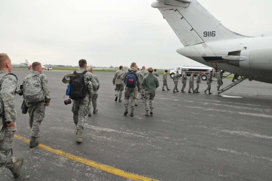 Members of the 173rd Fighter Wing in Klamath Falls, Ore. reboard a Navy C-9 aircraft out of Whidbey Naval Air Station, Wash. after a stop in Owensboro, Ky. for fuel.  The personnel left Kingsley Field earlier in the morning and continued on to Tyndall Air Force Base, Fla. Via Oceana, Md. March 18, 2011. (U.S. Air Force photo by Tech. Sgt. Jefferson Thompson) RELEASED