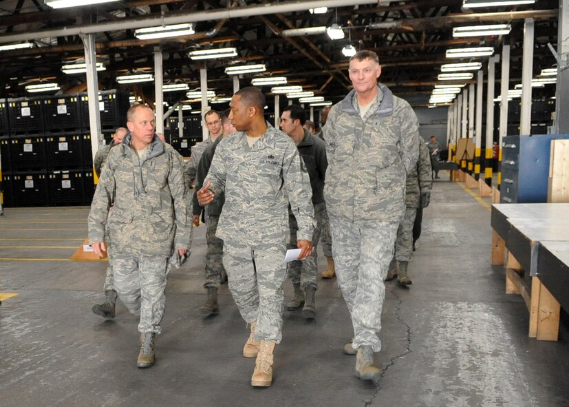 Master Sgt. Cedric Nettles (center), 51st Logistics Readiness Squadron section chief, briefs General Don Hoffman, Air Force Materiel Command commander (left), and Maj. Gen. Andrew Busch, Ogden Air Logistics Center commander, in the main Individual Protective Equipment warehouse at Osan Air Base, Republic of Korea March 9, 2011. The warehouse underwent a transformation beginning in January 2010 to reduce clutter and disorganization that left limited space to store IPE gear. After the re-warehousing effort, space saver bins and shelves are now used to organize IPE assets in stock number/contract/and lot number sequence. Gen. Hoffman visited with Pacific Air Forces area of responsibility to address issues dealing with logistics, installations, and mission support. (U.S. Air Force photo/Senior Airman Evelyn Chavez)