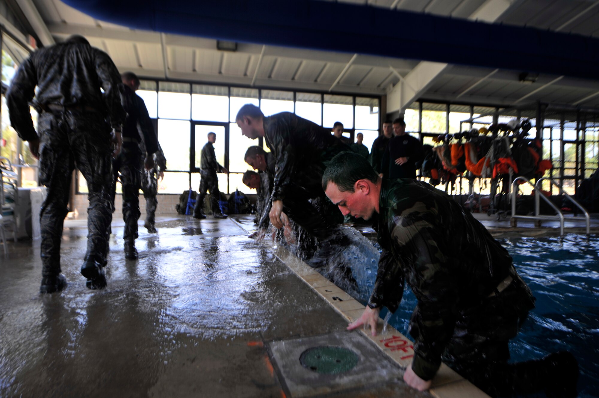 MOODY AIR FORCE BASE, Ga. -- Participants pull themselves out of the indoor pool after completing a portion of the water confidence assessment March 23. 
This was a portion of the air liaison officer aptitude assessment where members tested their minds and bodies to prove they were ready to be accepted into the ALO training course. (U.S. Air Force photo/Airman 1st Class Nicholas Benroth)(RELEASED)
