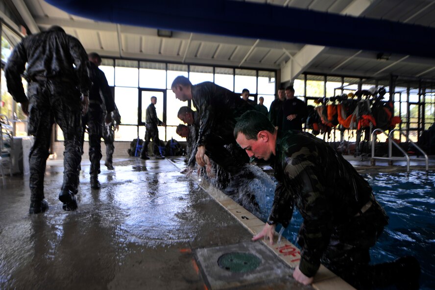 MOODY AIR FORCE BASE, Ga. -- Participants pull themselves out of the indoor pool after completing a portion of the water confidence assessment March 23. 
This was a portion of the air liaison officer aptitude assessment where members tested their minds and bodies to prove they were ready to be accepted into the ALO training course. (U.S. Air Force photo/Airman 1st Class Nicholas Benroth)(RELEASED)
