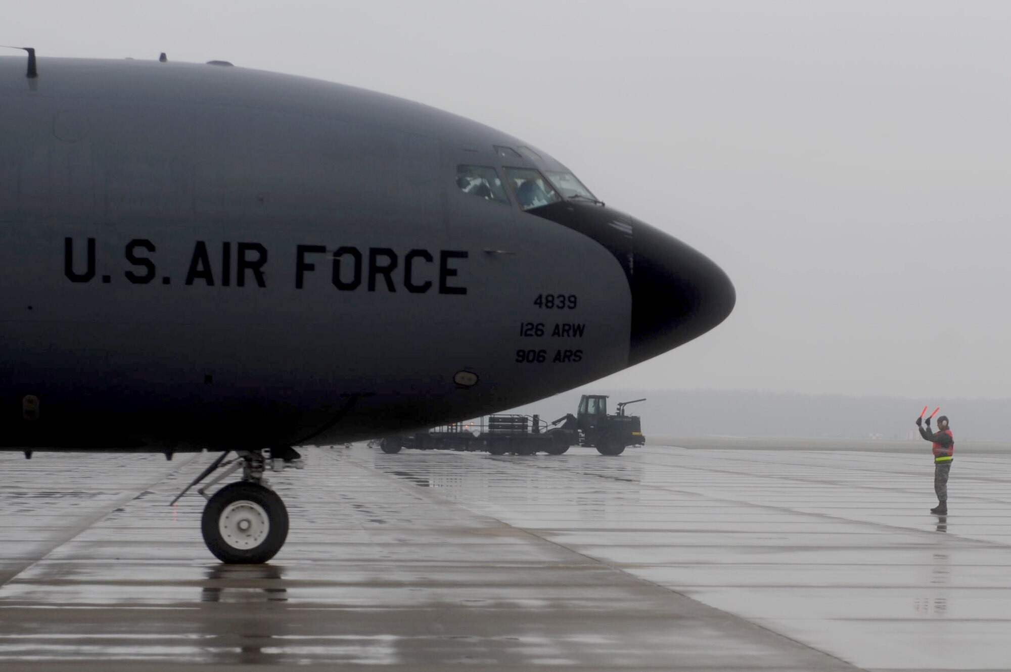 A member of the Illinois Air National Guard's 126th Air Refueling Wing marshals a KC-135 Stratotanker March 25, 2011, at Scott Air Force Base, Ill., in preparation for deployment in support of Operation Odyssey Dawn.  (U.S. Air Force photo/Staff Sgt. Brian J. Valencia)
