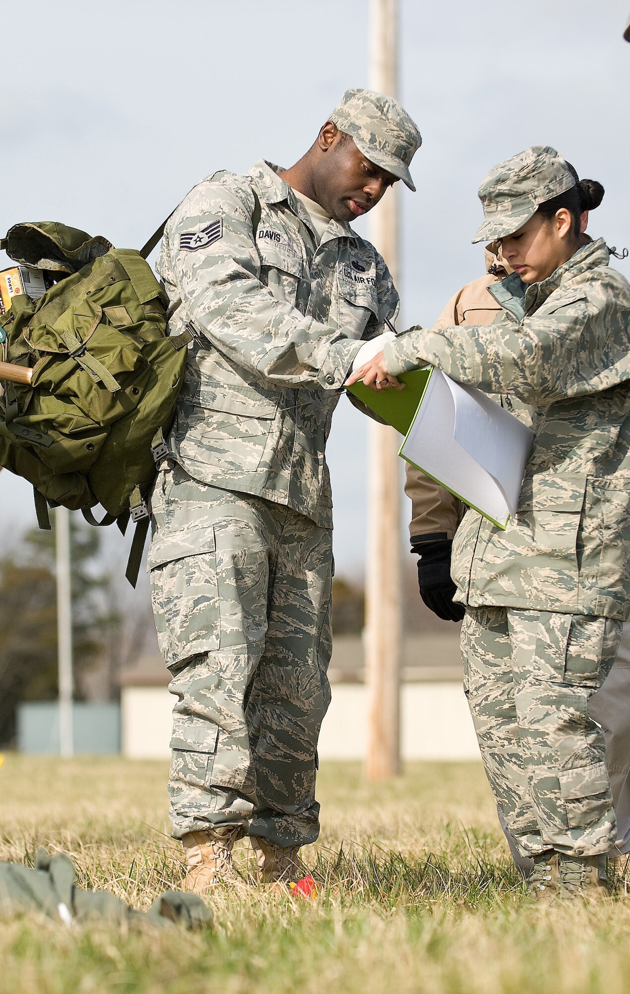 Staff Sgt. Martin Davis, and Airman 1st Class Yanet Rouillard, 436th Force Support Squadron, mark and plot a new item during a Search and Recovery training exercise here March 22, 2011. Sergeant Davis was a flagger and Airman Rouillard was a plotter for the S&R team. (U.S. Air Force photo/Roland Balik)