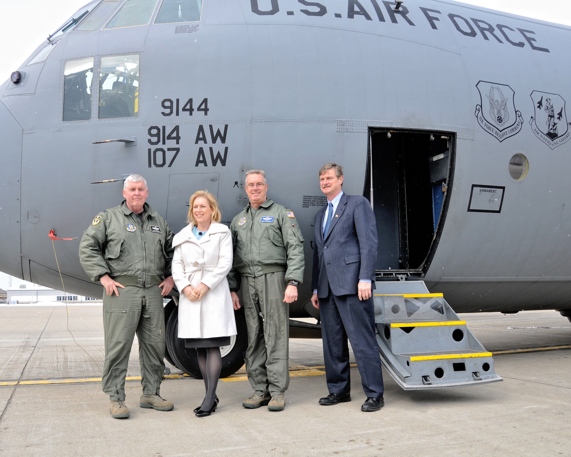 Posing next to a C-130 on the flightline New York Senator Kirsten Gillibrand stands between 914th Airlift Wing Vice Commander Col. Mark P. Murphy (left) and 107th Airlift Wing Commander Col. Jim S. McCready and Niagara Falls Mayor Paul Dyster, March 25, 2010, Niagara Falls Air Reserve Station, NY. During her visit Senator Gillibrand was given a tour of the base and answered questions from the media. (U.S. Air Force photo by Staff Sgt. Joseph McKee)