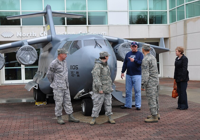 315th Airlift Wing mini C-17 demo team members Master Sgt. Michele Summers, Tech. Sgt. Nelson Irizarry and Tech. Sgt. Glenn Walker, all of the 315th Aircraft Maintenance Squadron, display the mini C-17 at the last home game of the regular season for the South Carolina Stingrays ECHL hockey team March 27. (U.S. Air Force photo by Capt. Wayne Capps)