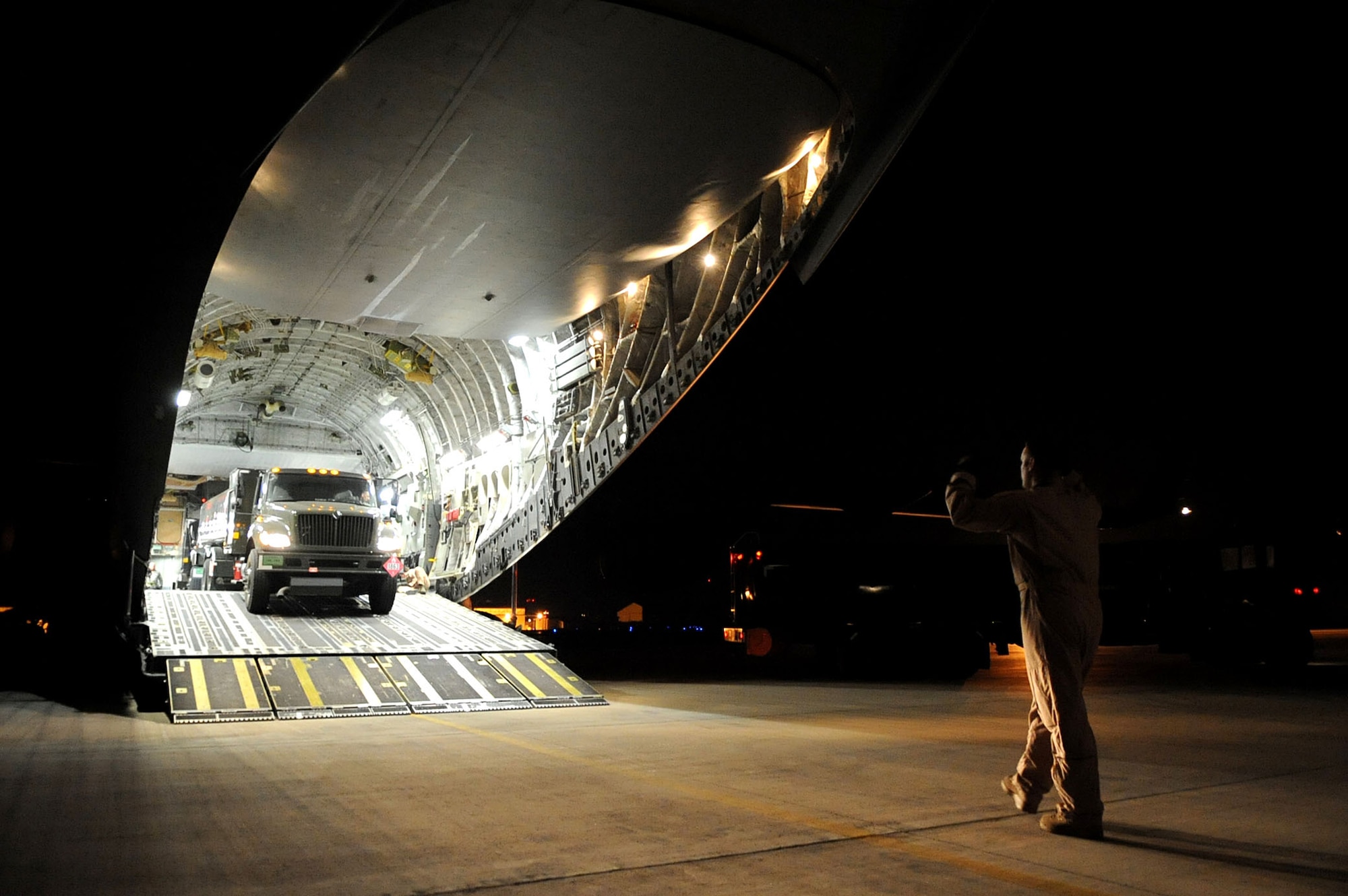 Loadmasters prepare to unload a refueling truck from a C-17 Globemaster III March 23, 2011, at Aviano Air Base, Italy, in support of Operation Odyssey Dawn. (U.S. Army photo/Army Staff Sgt. Tierney P. Wilson)