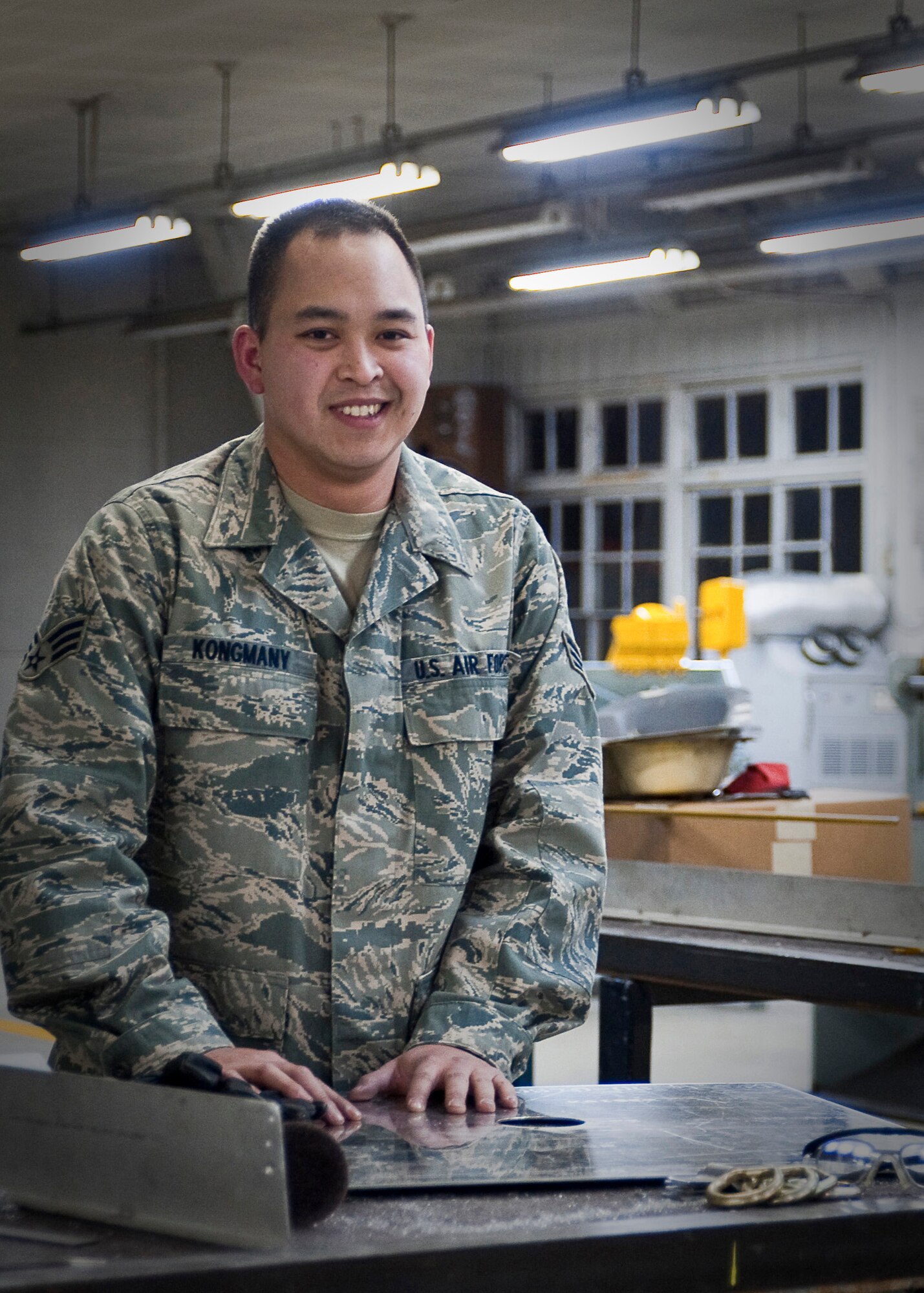 YOKOTA AIR BASE, Japan -- Senior Airman Thompson Kongmany, 374th Maintenance Squadron, stands here at the metals technology shop March 28, 2011. A native of Spring Dale, Ark., Airman Kongmany is a aircraft structural maintenance technician stationed here in Japan and is currently supporting Operation Tomodachi, which kicked off at the request of the Government of Japan to support humanitarian relief efforts for those affected by the earthquake tsunami disaster March 11. (U.S. Air Force photo/Airman 1st Class Andrea Salazar)