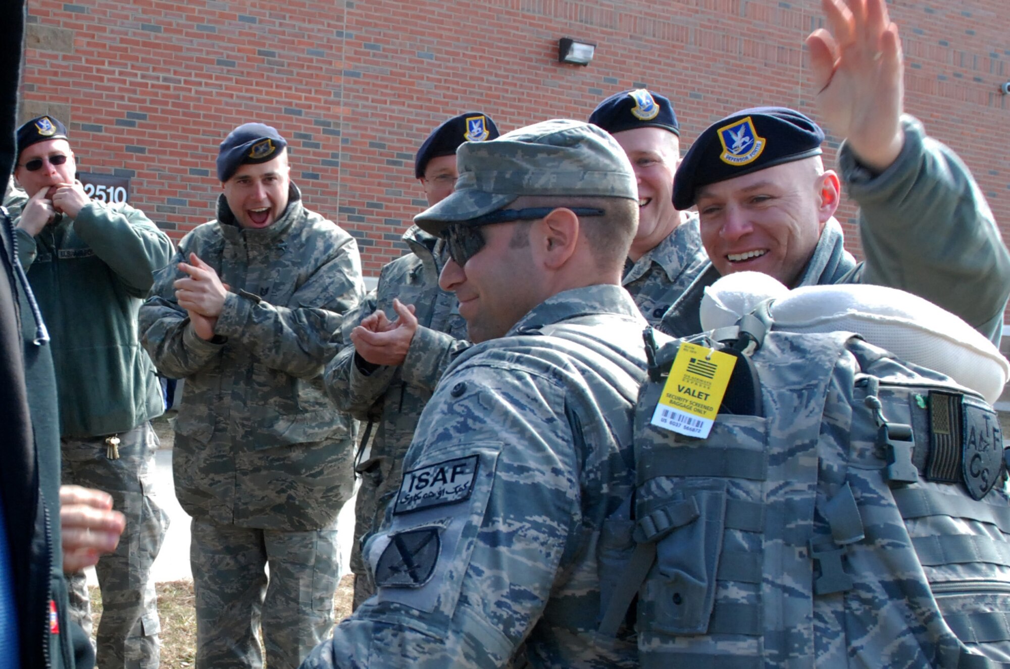 Security Forces from the 439th Airlift Wing were greeted by almost 100 family and fellow reservists as they came home from a 180-day-tour in Afghanistan. Their bus was escorted to the teary-eyed and enthusiastic crowd near the Security Forces building at Westover by the Chicopee Police Department. (US Air Force photo/Master Sgt. Andrew Biscoe)