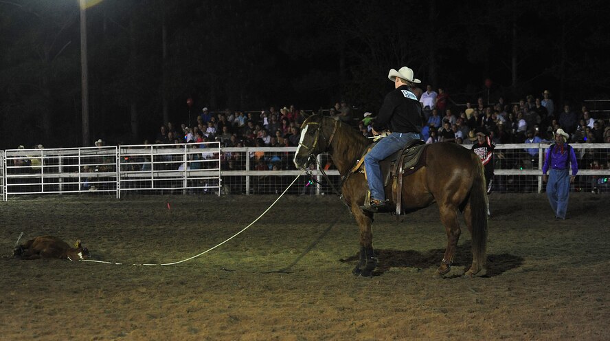 MOODY AIR FORCE BASE, Ga.-- A cowboy remounts his horse after roping a calf March 25. The calf must remain tied for six seconds or the cowboy’s score reads “no time.” (U.S. Air Force photo/Senior Airman Stephanie Mancha)(RELEASED) 

