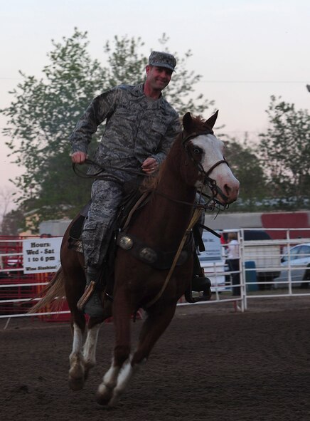MOODY AIR FORCE BASE, Ga.-- Col.  Gary Henderson, 23rd Wing commander, rides into the arena of the Cotton Blossom Round-up Rodeo March 25. Colonel Henderson and Chief Master Sgt. Frank Batten, 23rd WG command chief, were invited to start the rodeo off by riding  horses for the military appreciation day.(U.S. Air Force photo/Senior Airman Stephanie Mancha)(RELEASED)
