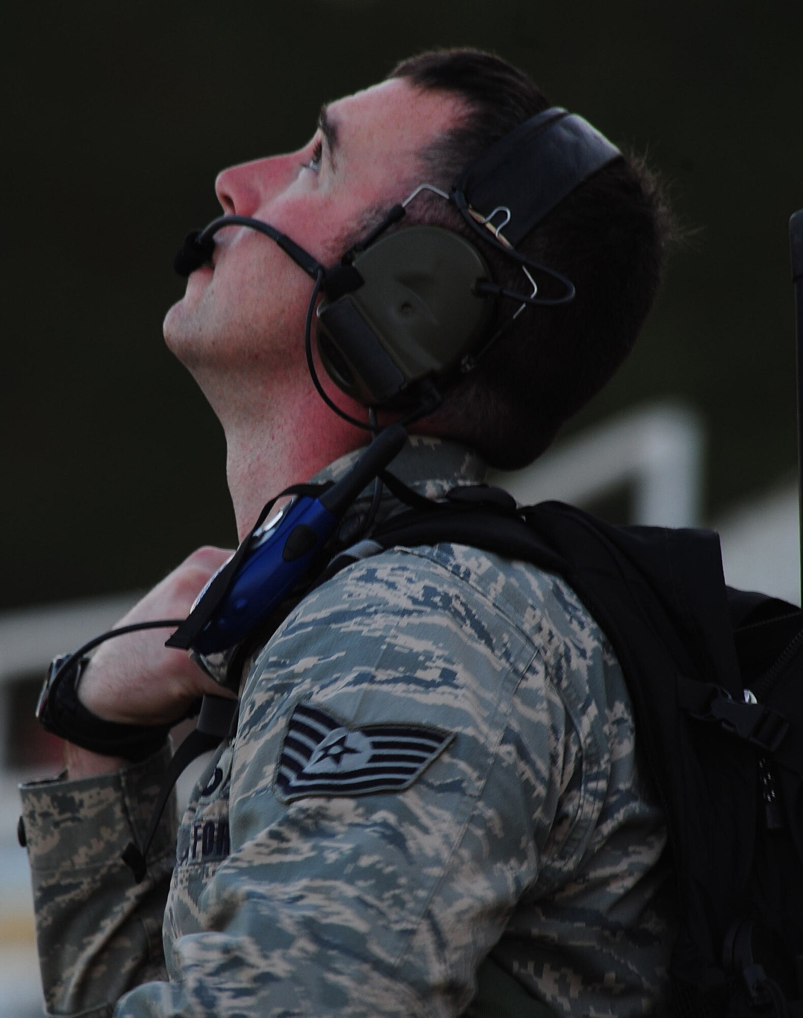 MOODY AIR FORCE BASE, Ga.--Tech. Sgt. Clayton Morris, 38th Rescue Squadron aircrew flight equipment NCO in charge, communicates with the pilot and pararescuemen before the jump March 25. Sergeant Morris remained in contact with the members aboard the aircraft the entire time to coordinate the timing of the drop.  (U.S. Air Force photo/Senior Airman Stephanie Mancha)(RELEASED)
