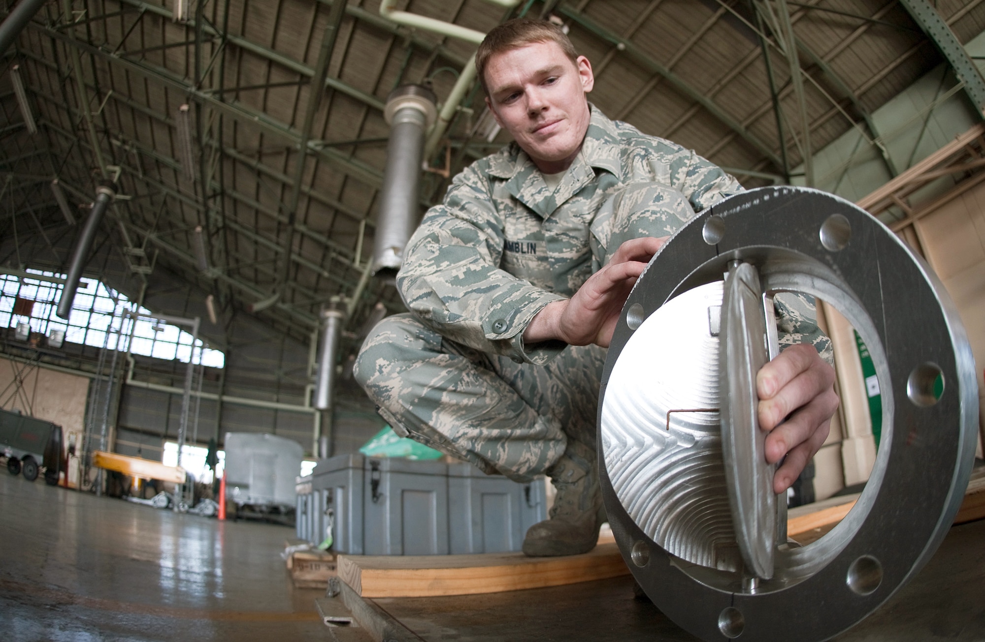 Airman 1st Class Jeremy Hamblin delivers a component for a water pump March 27, 2011, at Yokota Air Base, Japan. Two teams of four Airmen on 12-hour shifts designed and created the necessary adapters, pressure valves and other pieces so Japanese crews could use the pumps to augment the plant's cooling system. The pumps will be used to transport fresh water into the plant instead of ocean water, which leaves corroding salt residue when it evaporates. Hamblin is assigned to the 374th Maintenance Squadron. (U.S. Air Force photo/Osakabe Yasuo)

