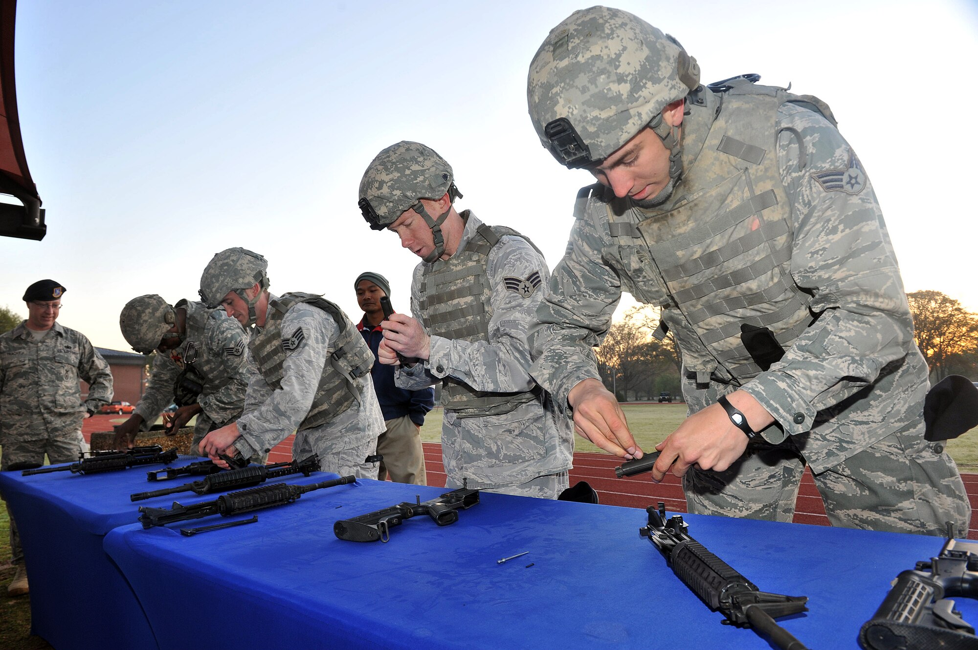 Military Challenge participants assemble and disassemble an M4 carbine. U.S. Air Force Photo by Tommie Horton.