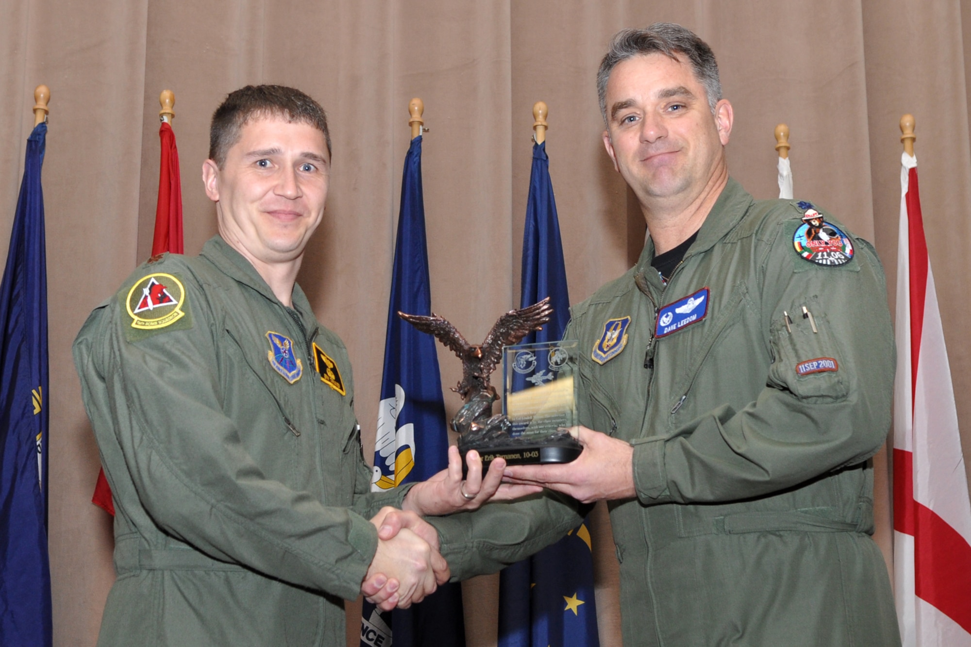 Lt. Col. David Leedom, commander, 93rd Bomb Squadron, presents the Lindell Mabus Leadership award to Maj. Erik Tarnanen during the graduation ceremony for Formal Training Unit Class 10-03, in Hoban Hall at Barksdale Air Force Base, La., March 11, 2011. The awarded is named after Lt. Col. Lindel Mabus, who was the first 93rd Bomb Squadron commander, when the squadron was reactivated in 1993. Major Tarnanen is the first to ever be presented with the award.  Simply put, the award is given to the student in each class who’s class mates voted the most helpful to their class overall. A total of twenty-four students graduated from Class 10-03, and they will now report for duty to squadrons throughout the B-52 community. (U.S. Air Force photo/Tech. Sgt. Jeff Walston)

