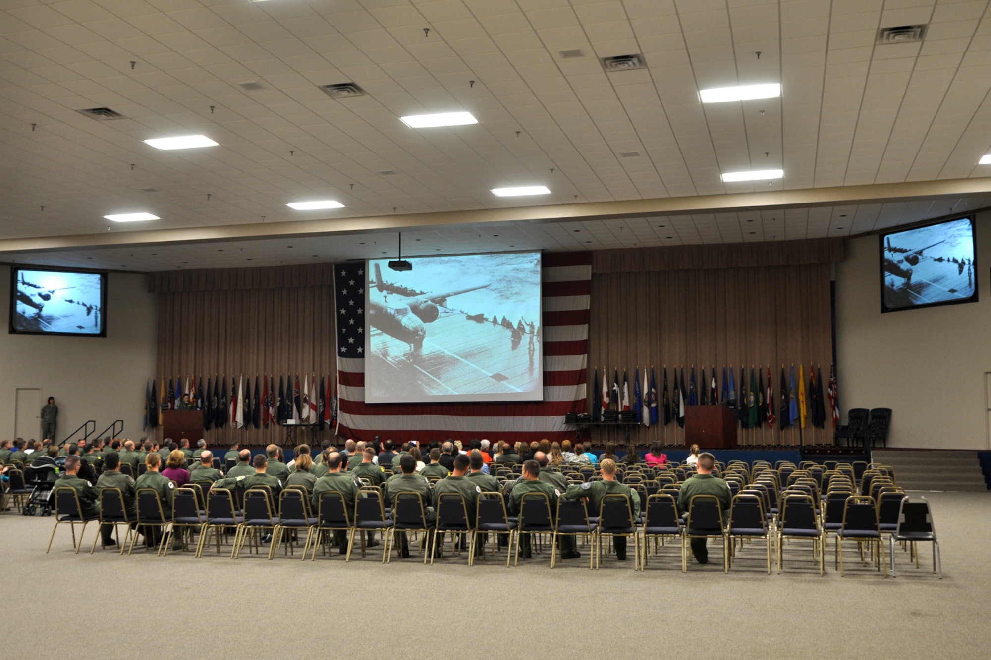 The audience at the 10-03 Formal Training Unit Graduation enjoys a video presentation before the ceremony begins in Hoban Hall at Barksdale Air Force Base, La., March 11, 2011. (U.S. Air Force photo/Tech. Sgt. Jeff Walston)  