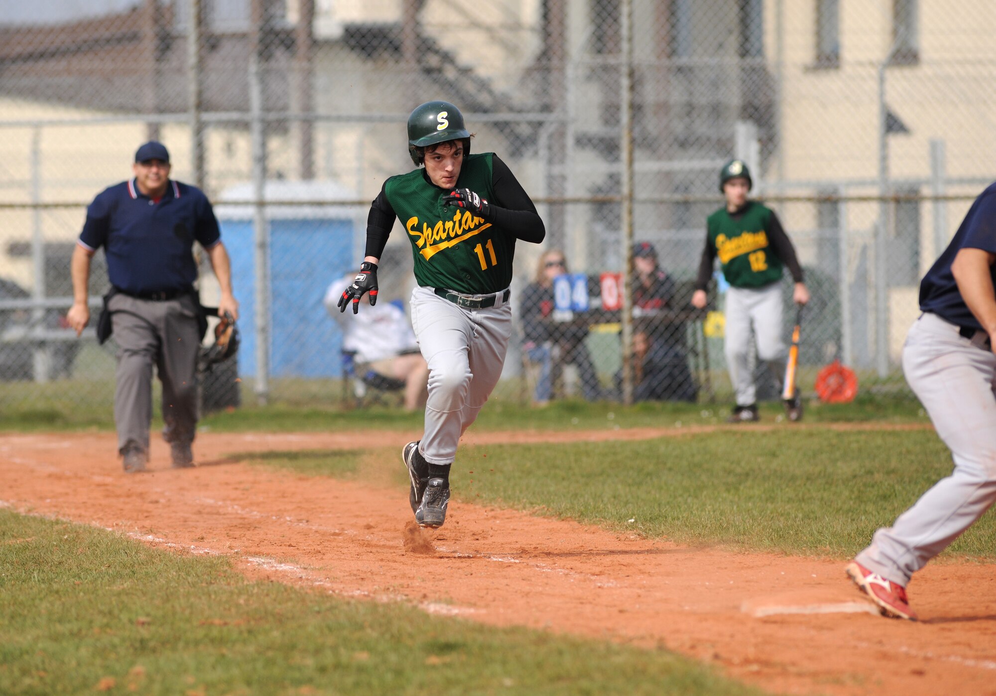 SPANGDAHLEM AIR BASE, Germany – Supreme Headquarters Allied Powers Europe American High School junior Collin Helfenstein runs toward first base during the opening game of the season against Bitburg High School here March 26. The SHAPE Spartans defeated the Bitburg Barons 5-4 the first game of a doubleheader.  The Barons defeated the Spartans 12-3 the second game. (U.S. Air Force photo/Senior Airman Nathanael Callon)