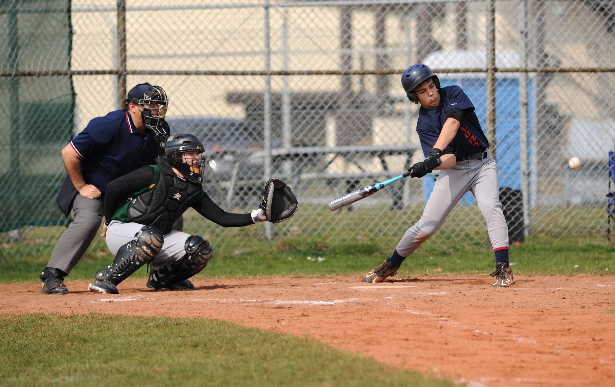 SPANGDAHLEM AIR BASE, Germany – Bitburg High School freshman Kenny Love takes a cut at the ball during the opening game of the season against Supreme Headquarters Allied Powers Europe American High School here March 26. The SHAPE Spartans defeated the Bitburg Barons 5-4 the first game of a doubleheader.  The Barons defeated the Spartans 12-3 the second game. (U.S. Air Force photo/Senior Airman Nathanael Callon)
