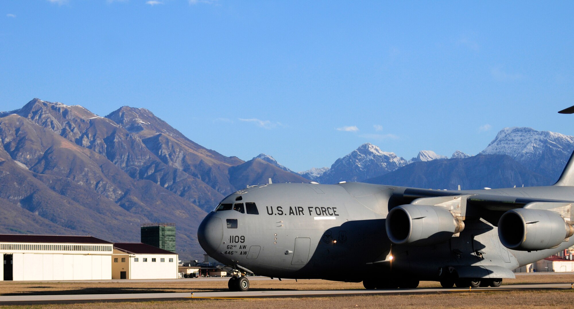 A C-17 Globemaster III from Joint Base Lewis-McChord, Wash., lands at Aviano Air Base, Italy, in support of Operation Odyssey Dawn on March 20, 2011. Joint Task Force Odyssey Dawn is the U.S. Africa Command task force established to support the larger international response to the unrest in Libya.  A broad coalition of nations are partnering to enforce U.N. Security Council Resolution (UNSCR) 1973, which authorizes all necessary means to protect civilians in Libya under threat of attack by Qadhafi regime forces.  JTF Odyssey Dawn is commanded by Admiral Samuel J. Locklear, III. (U.S. Air Force Photo/Airman 1st Class Katherine Windish)