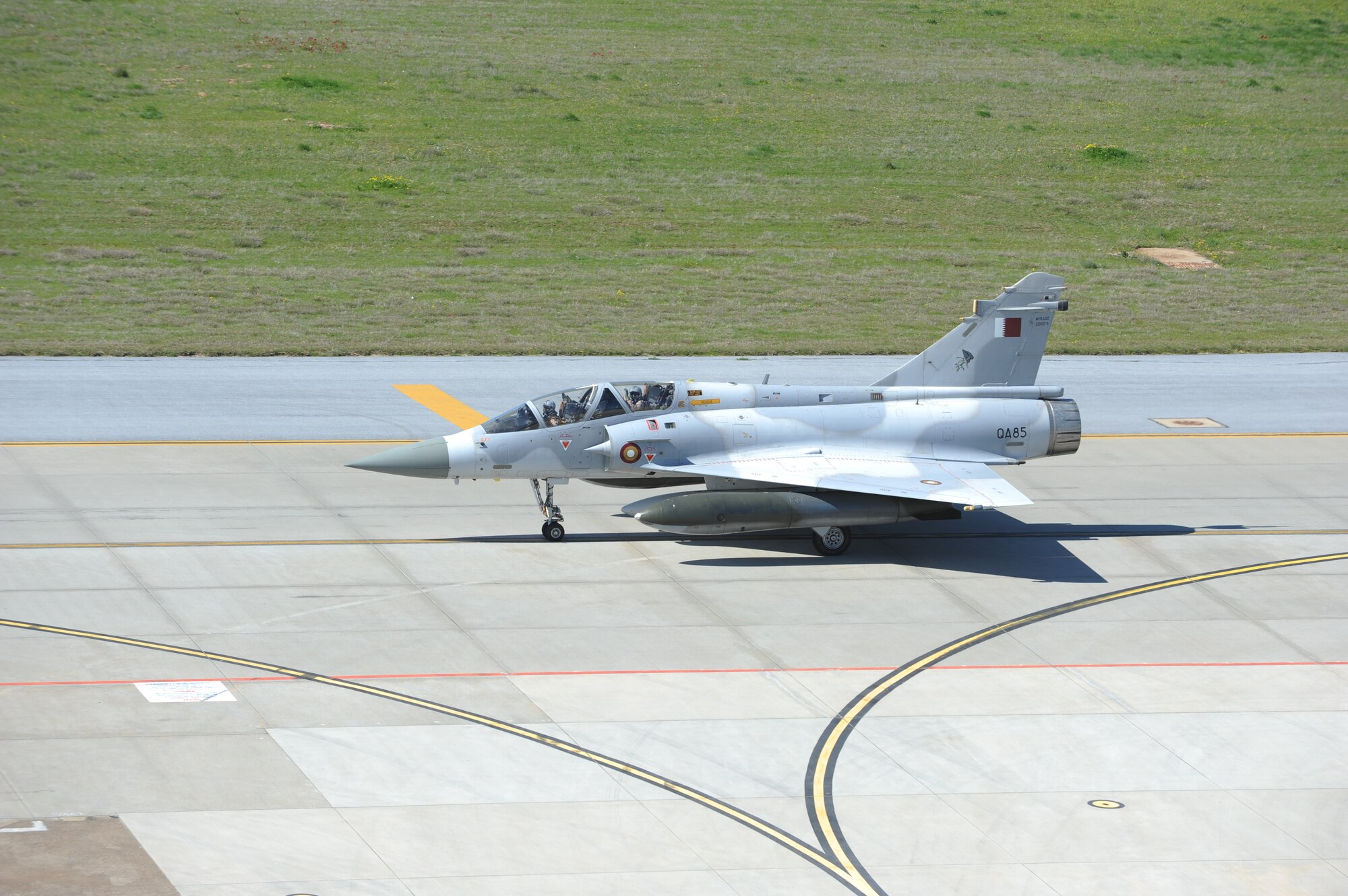 Crew members inside a Mirage F-1 from Qatar wave as the plane taxies down the runway to refuel in support of Operation Odyssey Dawn, March 25, 2011, at Incirlik Air Base, Turkey.  Joint Task Force Odyssey Dawn is the U.S. Africa Command task force established to provide operational and tactical command and control of U.S. military forces supporting the international response to the unrest in Libya and enforcement of United Nations Security Council Resolution 1973. UNSCR 1973 authorized all necessary measures to protect civilians in Libya under threat of attack by Qadhafi regime forces. JTF Odyssey Dawn is commanded by U.S. Navy Admiral Samuel J. Locklear, III. (U.S. Air Force photo by Airman 1st Class Clayton Lenhardt)