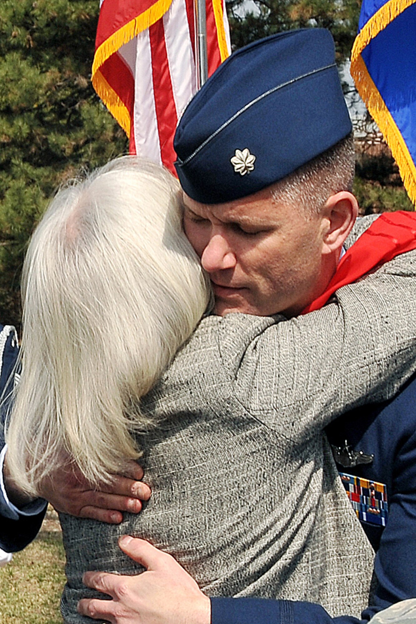 OFFUTT AIR FORCE BASE, Neb. - Jan York, the mother of Lt. Col. Mark Stratton II, hugs Lt. Col. Brian Humphrey, 45th Reconnaissance Squadron commander, during a a road rededication ceremony held in the honor of Colonel Stratton on the corner of SAC Boulevard here March 24. U.S. Air Force Photo by Charles Haymond