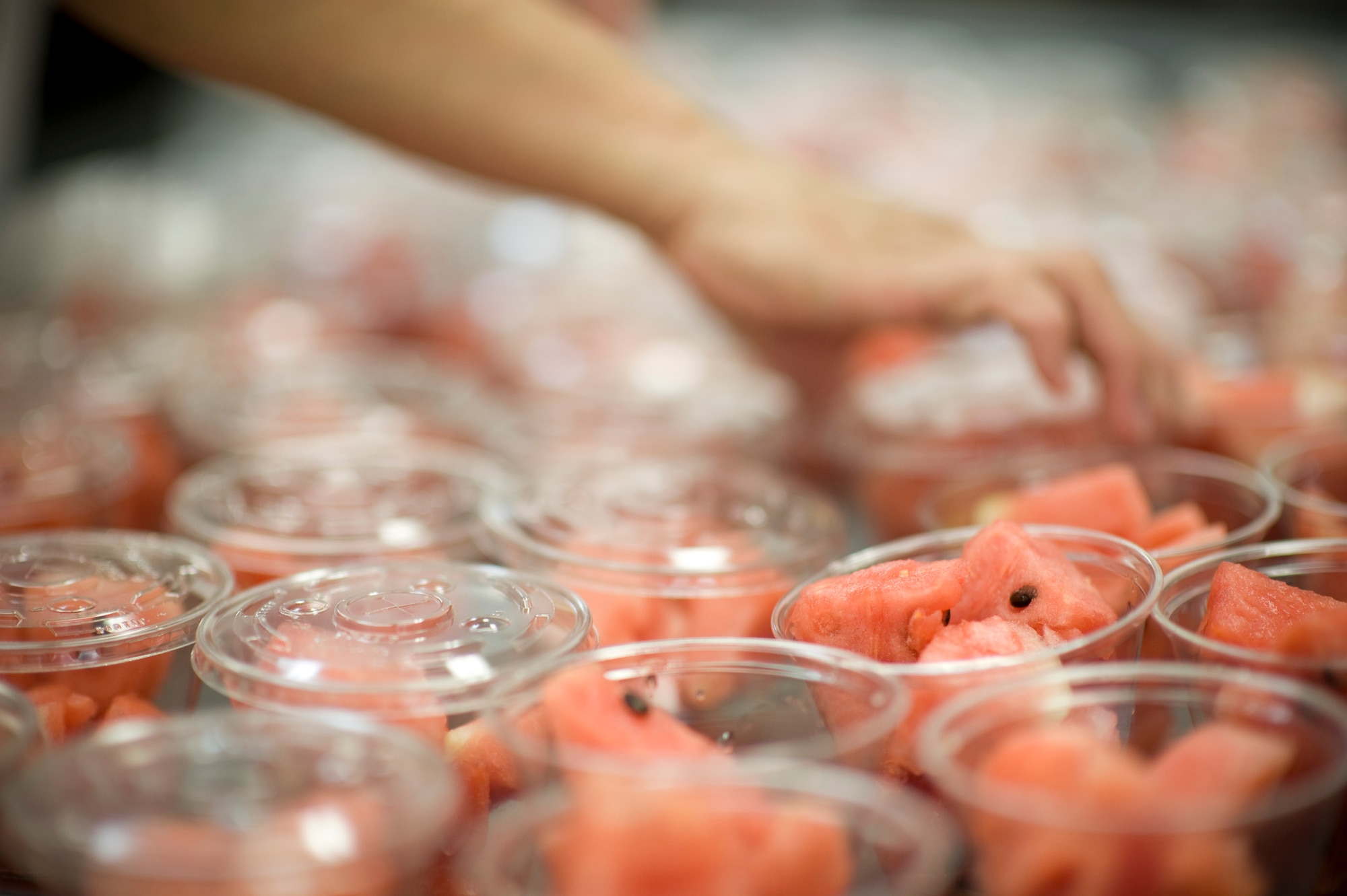 YOKOTA AIR BASE, Japan -- A food services technician prepares individual servings of watermelon at the Samurai Cafe, Yokota Air Base, Japan, March 23, 2011.The Samurai Cafe has increased meal servings from 800-2,000 due to an influx of people deployed to Yokota in support of Operation Tomodachi. (U.S. Air Force photo/Staff Sgt. Samuel Morse)