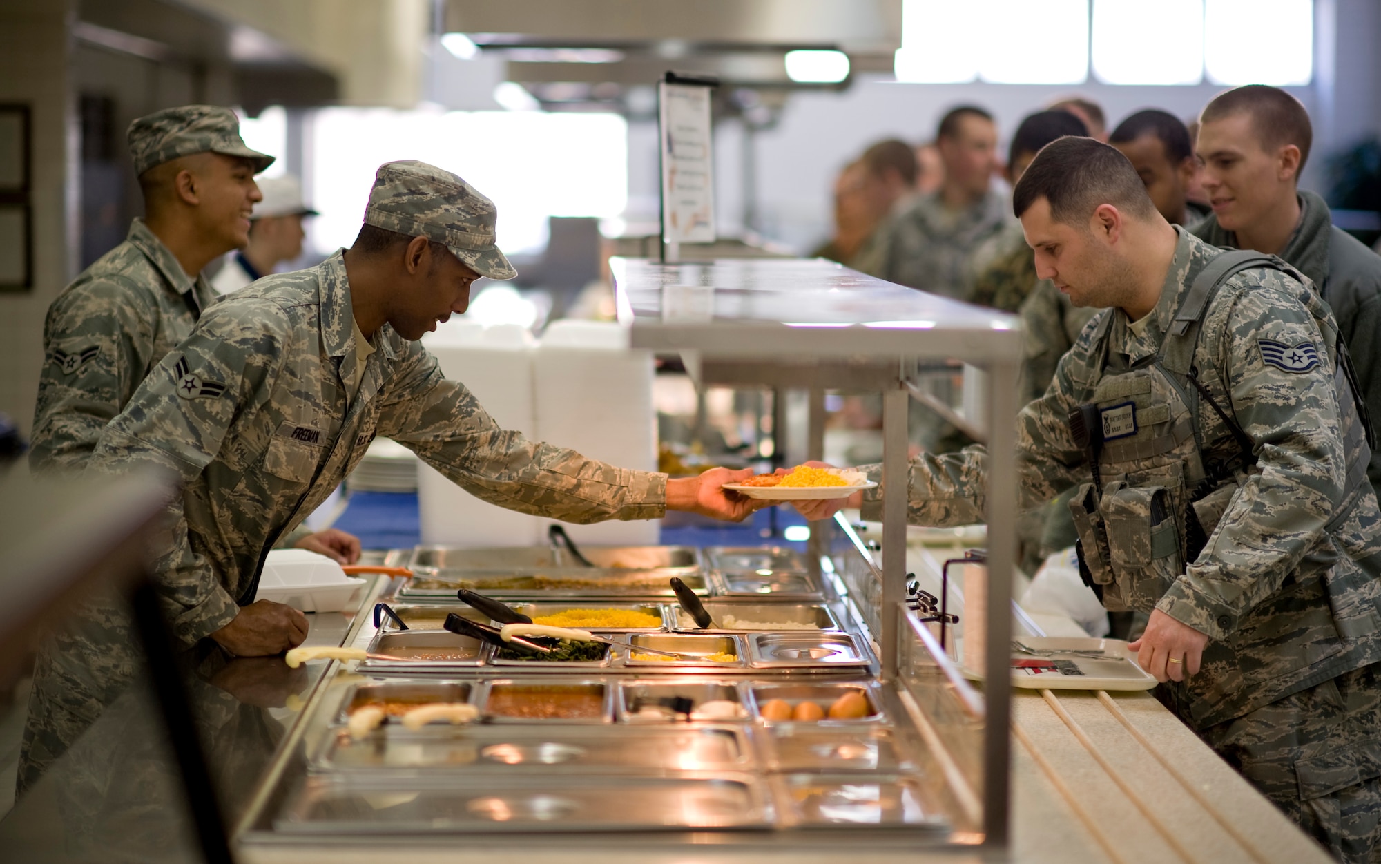 YOKOTA AIR BASE, Japan -- Airman 1st Class Marcus Freeman serves food at the Samurai Caf?, Yokota Air Base, Japan, March 23, 2011. Airman Freeman is an augmentee from Elmendorf Air Force Base, Alaska that is temporarily deployed to Yokota in support of Operation Tomodachi. (U.S. Air Force photo/Staff Sgt. Samuel Morse) 