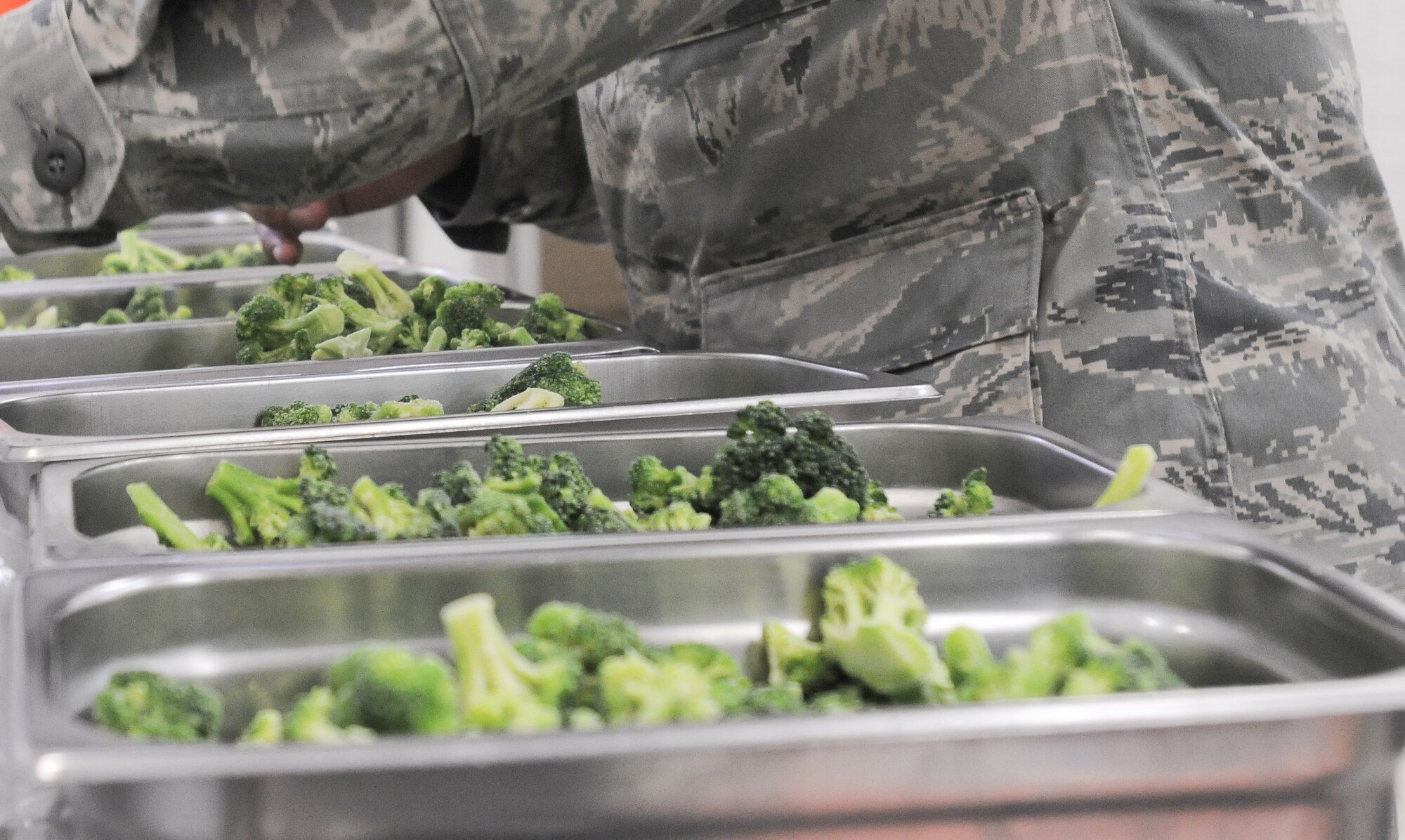 YOKOTA AIR BASE, Japan -- Airman 1st Class Mario Acevedo prepares vegetables for lunch March 21, 2011. Airmen working at the Samurai Cafe have gone from serving 800 to 2,000 meals, this is due to the influx of people deployed to Yokota Air Base in support of Operation Tomodachi. Airman Acevedo is a member of the 374th Force Support Squadron. (U.S. Air Force photo/Airman 1st Class Krystal M. Garrett) 