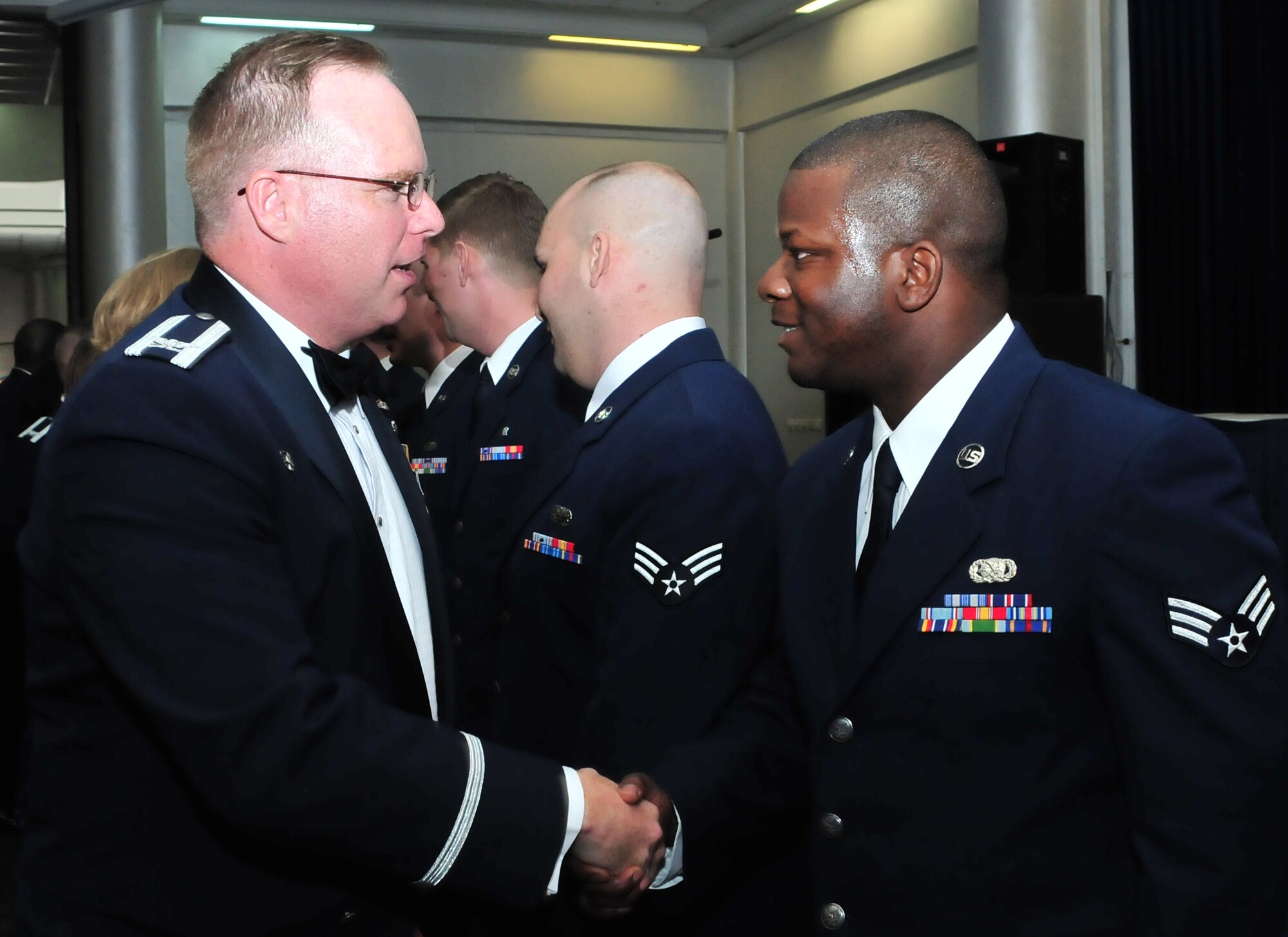 Col. Eric Beene, the 39th Air Base Wing commander, congratulates Senior Airman Jarrett Sanford, from the 39th Logistics Readiness Squadron, and his 15 classmates after an Airman Leadership School graduation in the Club Complex March 18, 2011, at Incirlik Air Base, Turkey.  ALS is one of the many professional military education courses in the Air Force. Airman Leadership school prepares and trains future noncommissioned officers for increased responsibilities. The graduates of class 11-4 were Senior Airmen Scott Adams, Nequitta Brown, Andrew Cockerham, Jordan Dottin, Wynn Dressler, Brandon Gannon, Charles Gill, Amos Glenn, Travis Goar, Rebecca Graham, Jacob Marroquin, Jason Rundell, Jarrett Sanford, Jonathan Smith, Michael Watkins, and Joseph White. (U.S. Air Force photo by Staff Sgt. Alexandre Montes/Released)