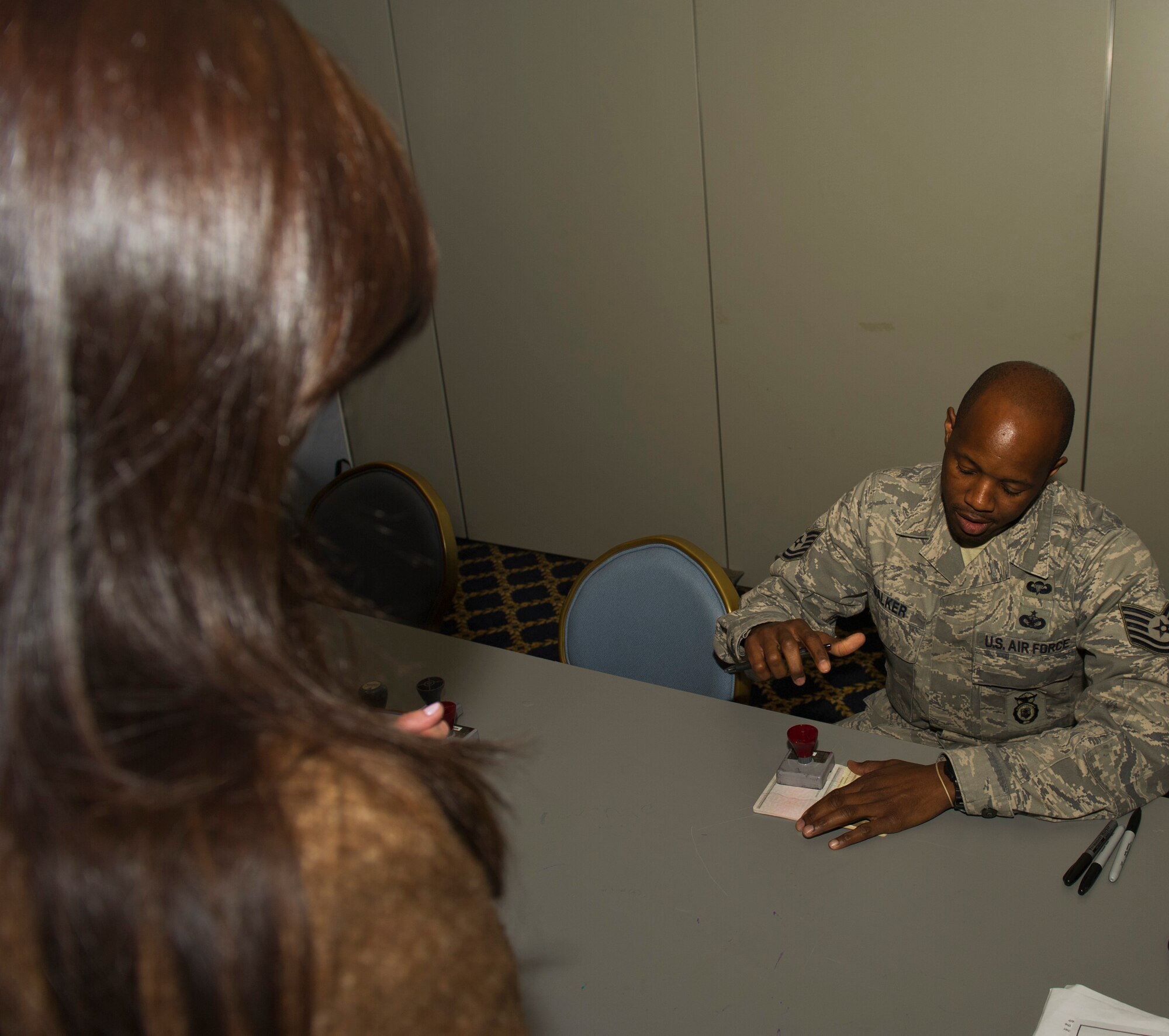 YOKOTA AIR BASE, Japan -- Tech. Sgt. Robert Williams processes military dependants at the Taiyo Recreation Center as part of the voluntary authorized departures March 28. Members of the 374th Security Forces Squadron have acted as customs officers during Operation Tomodachi, processing more than 3,000 military dependants from Yokota and neighboring military bases. Sergeant Williams is assigned to the 374th SFS serving as the non-commissioned officer-in-charge of customs and immigration. (U.S. Air Force photo/Senior Airman Michael J. Veloz) 