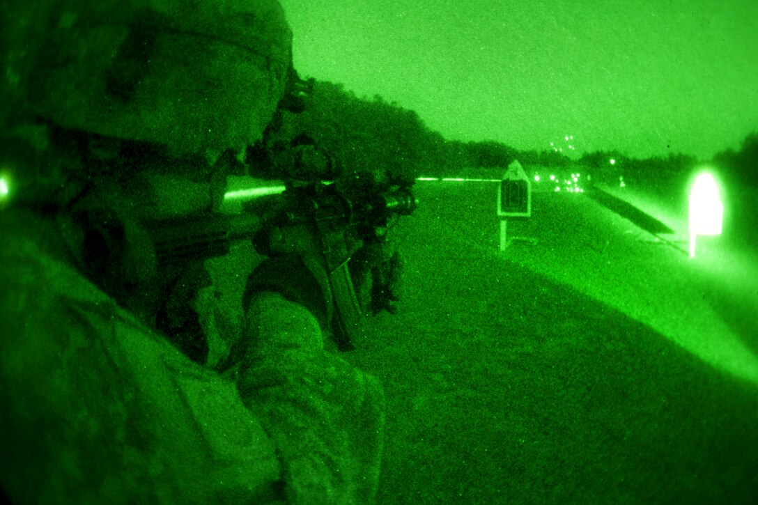 As seen through a night-vision device, a U.S. Army paratrooper uses night-vision goggles and a PEQ-15 laser to fire his M-4 carbine at targets during night-fire training on Fort Bragg, N.C., March 23, 2011. 